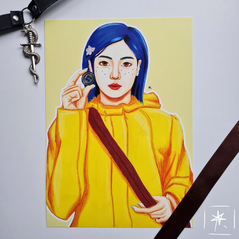 May include: A hand-drawn illustration of a girl with blue hair wearing a yellow raincoat and holding a button. The girl has freckles and is looking at the button.