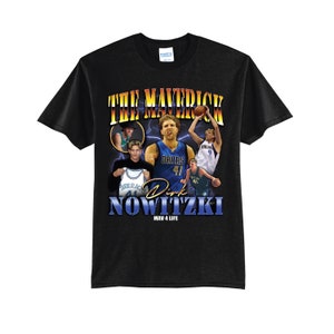 May include: Black t-shirt with a graphic of basketball player Dirk Nowitzki in a Dallas Mavericks jersey. The text "The Maverick Dirk Nowitzki Mav 4 Life" is printed on the shirt.