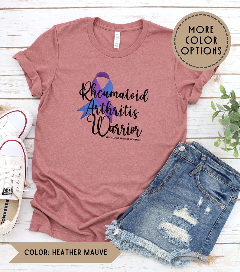 May include: Heather mauve t-shirt with a purple ribbon and the text "Rheumatoid Arthritis Warrior #rheumatoidarthritisawareness".