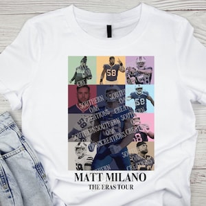 May include: A white t-shirt with a collage of photos of a football player in different uniforms. The text "MATT MILANO THE ERAS TOUR" is printed below the collage.