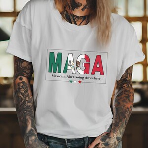 May include: White t-shirt with a red, white, and green graphic that says "MAGA" and "Mexicans Ain't Going Anywhere".