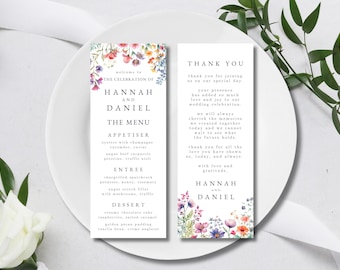 Op de afbeelding: Huwelijksmenu en bedankkaartjes met bloemenmotieven. Het menu bevat voorgerechten, hoofdgerecht en dessert. De bedankkaart drukt dankbaarheid uit aan de gasten voor hun aanwezigheid op de huwelijksviering.