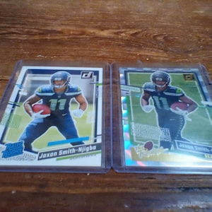 jaxon smith-njigba rookie card bundle of 2 donruss 2023 the rookies #7 and donruss 2023 rated rookie #390 both raw near mint condition