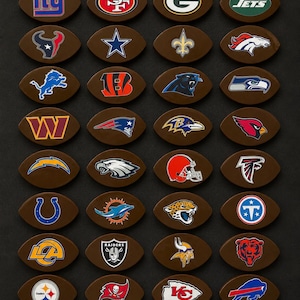 May include: A collection of thirty-two brown, football-shaped items, each featuring a unique National Football League team logo. The logos include various animals, letters, and symbols representing professional American football teams.