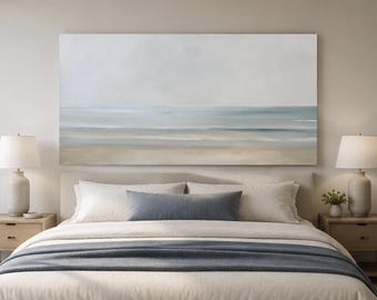 May include: A large rectangular wall art piece featuring an abstract coastal landscape with soft horizontal bands of beige, light blue, and white, depicting a calm shoreline, ocean, and sky in a muted, blended color palette.