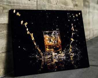 May include: A glass of amber liquid with ice cubes is splashed with liquid, creating a dramatic effect against a black background.