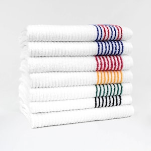 May include: A stack of seven white rectangular towels with a ribbed texture. Each towel features a distinct horizontal striped band on the right side in varying colors including blue, red, yellow, green, and black, with one plain white towel.