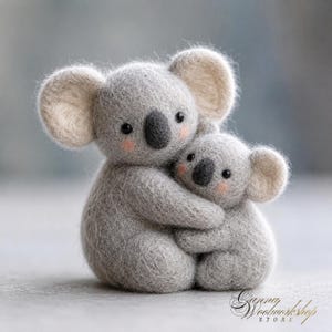 May include: A needle-felted wool sculpture of a large koala hugging a smaller koala. Both figures are light gray with dark gray noses, black eyes, and soft pink blush on their cheeks. The text Ganna Woolworkshop Store is visible in the corner.