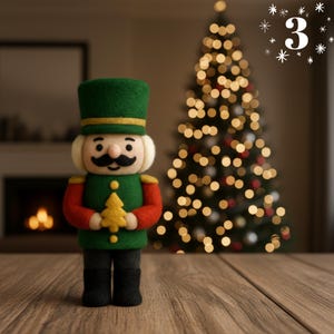 May include: A felt Christmas nutcracker figurine, wearing a green hat and jacket with gold trim, red sleeves, and black pants. The nutcracker holds a yellow tree. A Christmas tree with lights is in the background.