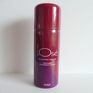 May include: A red and purple deodorant spray bottle with the text "j'ai Osé DEODORANT PARFUME PERFUMED DEODORANT SPRAY PARIS" on the label.