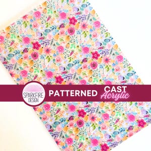May include: Patterned cast acrylic sheet with a vibrant floral design. The sheet features a watercolor-style pattern of pink, purple, yellow, and blue flowers with green leaves. The text "PATTERNED CAST Acrylic" is displayed on a burgundy banner.