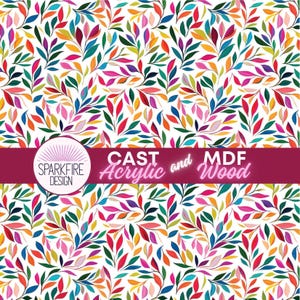 May include: A vibrant pattern of colorful leaves in shades of red, orange, yellow, green, blue, and purple against a white background. The design includes the text "CAST Acrylic and MDF Wood" and the "SPARKFIRE DESIGN" logo.