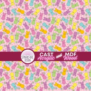 May include: A repeating pattern of colourful bunny-shaped marshmallow sweets and small white daisies on a light pink background. The image includes the text "CAST Acrylic and MDF Wood" and the Sparkfire Design logo.