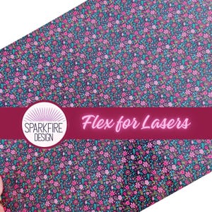 May include: A sheet of material with a floral pattern in pink, teal, and yellow on a dark background. The text "Flex for Lasers" is displayed in pink, along with a logo that says "Sparkfire Design".