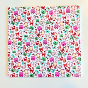 May include: White square tile with a repeating pattern of medical-themed illustrations. The design includes stethoscopes, face masks, bows, first aid kits, pill capsules, hand sanitizers, and pink slippers.