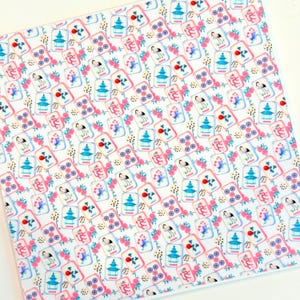 May include: A white fabric with a repeating pattern of colorful Mahjong tiles. The tiles feature pagodas, cranes, and floral designs in shades of blue, pink, and red. The word "Joker" is visible on some tiles.