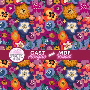 May include: A repeating floral pattern featuring stylized flowers in shades of magenta, orange, yellow, and blue on a dark background. A horizontal banner displays the text Sparkfire Design, Cast Acrylic and MDF Wood.