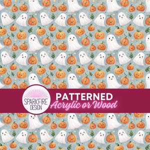 May include: A repeating pattern featuring white cartoon ghosts and orange pumpkins on a light blue background with small yellow stars. A horizontal magenta banner across the center displays the text SPARKFIRE DESIGN PATTERNED Acrylic or Wood.
