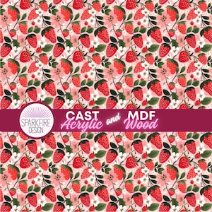 May include: A repeating pattern of red strawberries with green leaves and white flowers on a pink and white striped background. The design includes the text "CAST Acrylic and MDF Wood" and the Sparkfire Design logo.