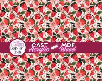 May include: A repeating pattern of red strawberries with green leaves and white flowers on a pink and white striped background. The design includes the text "CAST Acrylic and MDF Wood" and the Sparkfire Design logo.