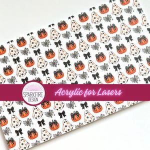 May include: White sheet with a repeating pattern of orange pumpkins, white ghosts, black bows, and spiderwebs. The sheet has a dark pink banner with the text "Acrylic for Lasers". The Sparkfire Design logo is in the lower left corner.