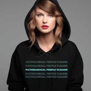May include: A woman wearing a black hooded sweatshirt with the text "PATHOLOGICAL PEOPLE PLEASER" repeated five times in a light blue color.