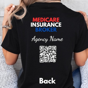 May include: A black t-shirt featuring the text MEDICARE INSURANCE BROKER in red, white, and blue, followed by the words Agency Name in white script, a square QR code, and the word Back printed in white at the bottom of the garment.