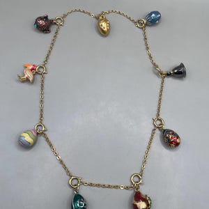 May include: A set of three ceramic mugs with a speckled, matte finish. The mugs are in shades of cream, light gray, and dark gray. Each mug has a simple, minimalist design, perfect for coffee or tea.