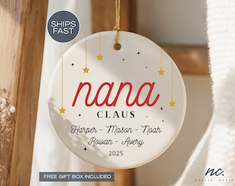 May include: A white ceramic Christmas ornament with the word "nana" in red script. The ornament includes the names of family members and the year 2025, with star and plus decorations. A gold string is attached for hanging.