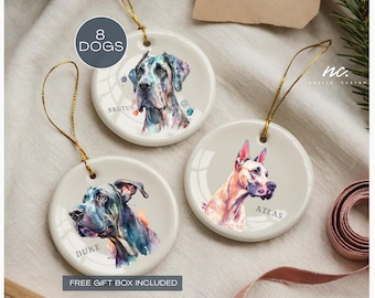 May include: Three round ceramic ornaments with watercolor portraits of dogs. Each ornament has a gold string for hanging. The dogs are named Brutus, Duke, and Atlas. The text "8 DOGS" is in a circle at the top.