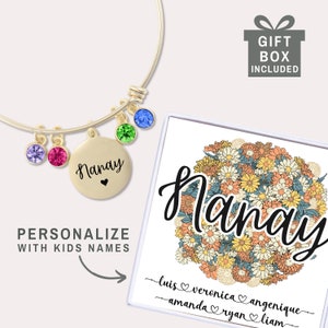 May include: Gold bangle bracelet with a charm that says "Nanay" and a heart. The bracelet has colorful crystals attached. The bracelet comes in a gift box with a floral design and the word "Nanay" written in a cursive font. The box also has space to personalize with names.