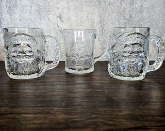 Your Choice: Vintage Clear Glass Christmas Holiday Embossed Luminarc Santa Claus or Arcoroc Evergreen Pine Tree Holly Berries Coffee Mugs