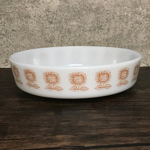 May include: White ceramic bowl with a brown sunflower pattern around the rim.