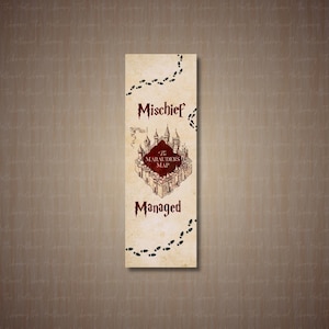 May include: A rectangular bookmark with a parchment-like background. The bookmark features the text "Mischief Managed" and a detailed illustration of a castle labeled "The Marauder's Map." Footprints and decorative elements complete the design.
