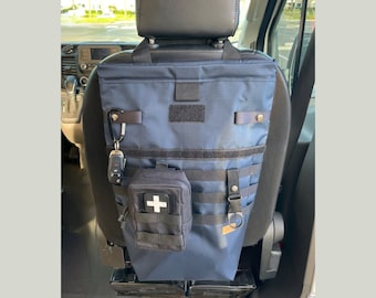 Seatback bag for trash, storage, or laundry. Great for any vehicle! MOLLE straps for extra storage. Magnetic Snap Back Closure.