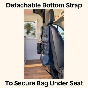 May include: A blue bag with a black strap is secured under a car seat using a detachable bottom strap. The strap is attached to the seat with a buckle. The bag has a small pocket on the front and a larger pocket on the side. "To Secure Bag Under Seat" is written in black text at the bottom of the image.
