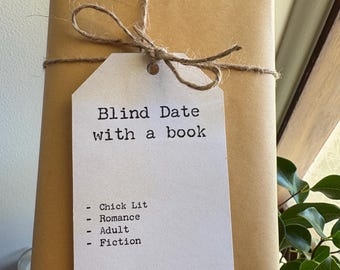 May include: A wrapped book in brown paper, tied with twine and a tag. The tag reads "Blind Date with a book" and lists genres: Chick Lit, Romance, Adult, and Fiction. The tag also has the number 15.