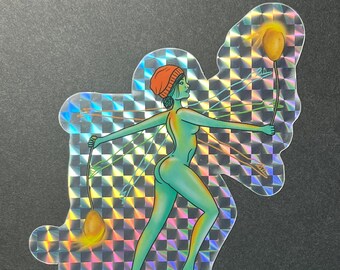 May include: A holographic sticker featuring a woman with an orange hat holding a glowing orb. The sticker has a checkered background and the text "nashedpoiiitato" at the bottom.