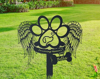 May include: Black metal garden stake with a paw print design and angel wings. The stake has the text "In Loving Memory" and "Bella" on it.