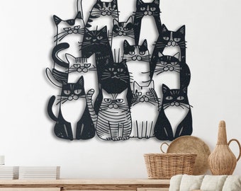 May include: Black and white metal wall art featuring a group of cats in various poses. The cats are arranged in a cluster, with some cats standing on top of others. The art is a whimsical and playful depiction of cats.