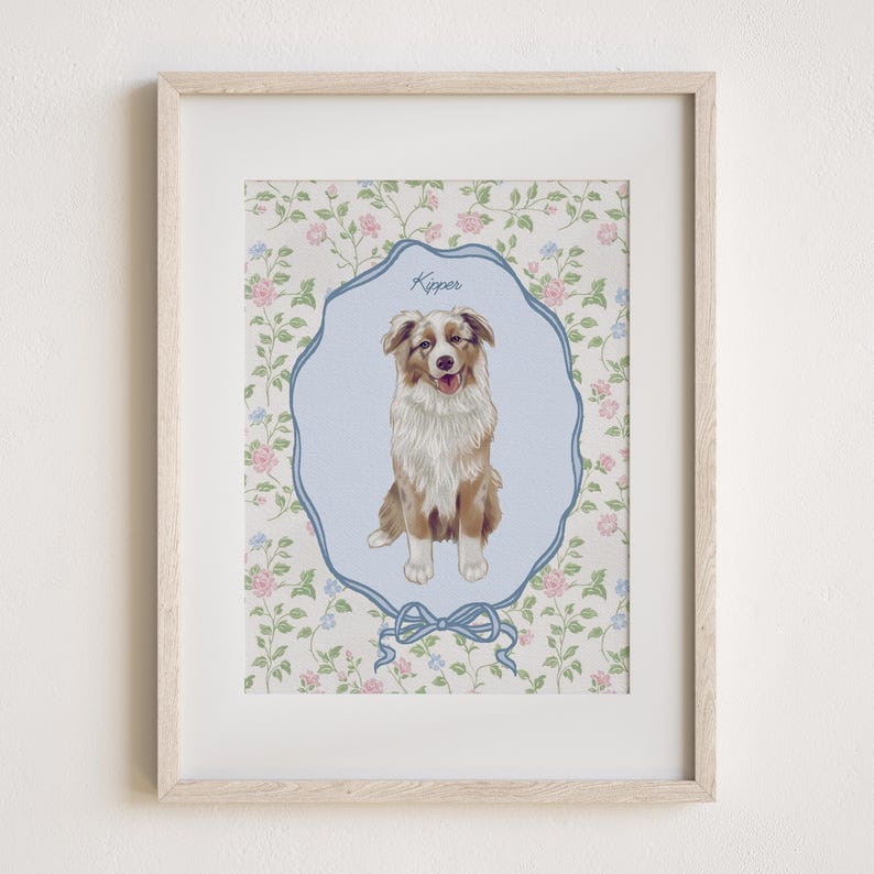 May include: Framed print featuring a dog illustration. The dog, with brown and white fur, is centered within a light blue, ornate frame. The background is a floral pattern with pink and blue flowers. The dog's name, "Kipper", is written above.