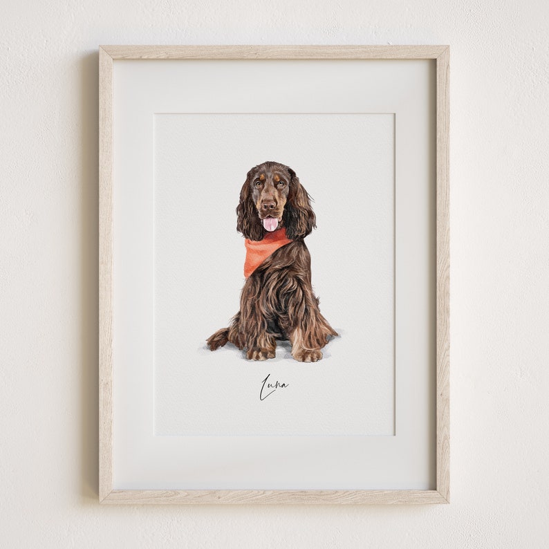 May include: A framed watercolor painting of a brown and white dog wearing a red bandana. The dog is sitting and looking at the camera. The painting is signed "Luna".