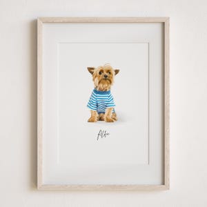 May include: A framed print of a Yorkshire Terrier wearing a blue and white striped shirt. The dog is sitting and looking up. The print is titled "Alfie".