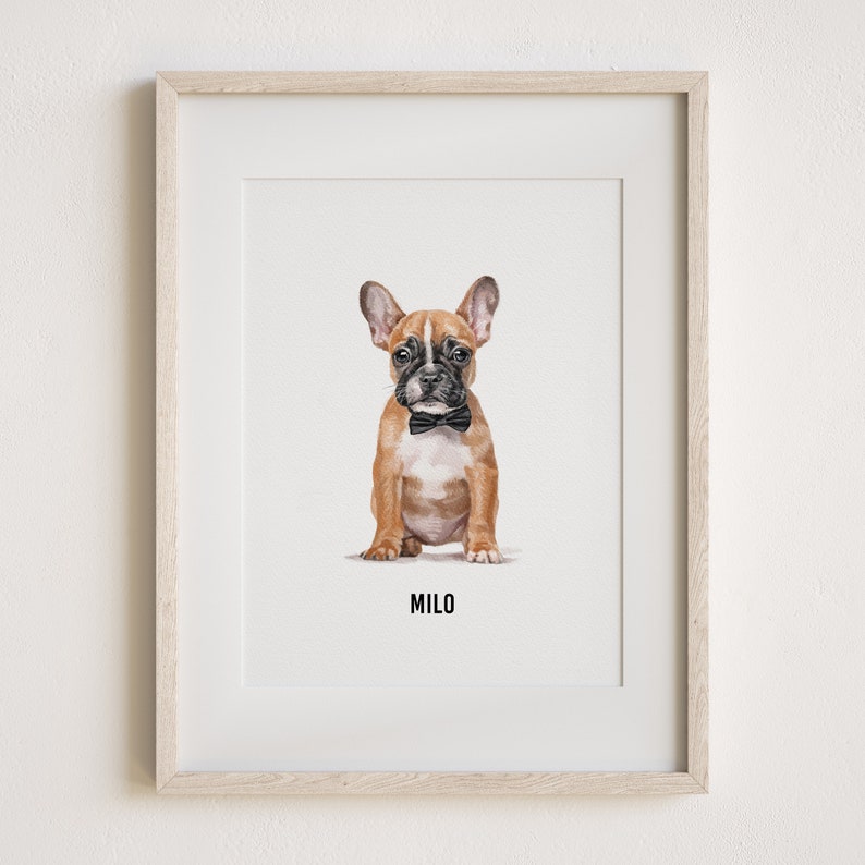 May include: A framed print of a brown and black French Bulldog puppy wearing a black bow tie. The puppy is sitting and looking at the camera. The print is titled "Milo".
