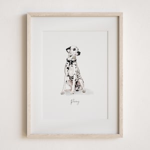 May include: A framed watercolour print of a Dalmatian dog. The dog is white with black spots and wears a black collar. The dog is sitting, and the name "Penny" is written below in cursive.