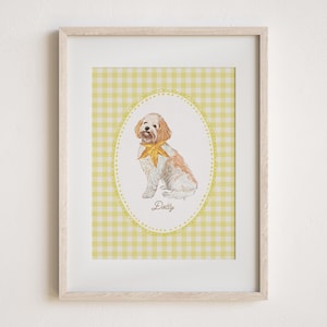 May include: A framed watercolor print of a dog named Dotty. The dog is white and brown with a yellow bow tie, set against a yellow gingham background within an oval frame. The print is in a light wood frame.