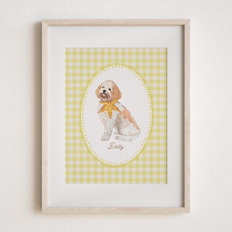 May include: A framed watercolor print of a dog named Dotty. The dog is white and brown with a yellow bow tie, set against a yellow gingham background within an oval frame. The print is in a light wood frame.