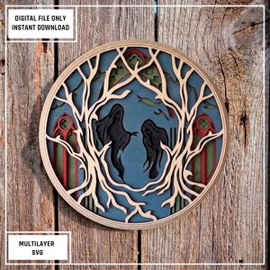 May include: A circular multilayered wall art piece featuring two dark ghost-like figures centered within a frame of bare, light-colored tree branches. The background displays blue tones with red and green gothic arch accents. Text reads: DIGITAL FILE ONLY INSTANT DOWNLOAD and MULTILAYER SVG.