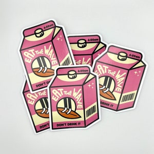 May include: Multiple stickers depicting a pink milk carton with the text 'Eat the Wave' and 'Don't Drink It'. The carton features a cartoon illustration of legs on a surfboard. Each sticker shows a 6:00am time stamp.  These stickers are ideal for surfers, beach lovers, or anyone who appreciates quirky designs.
