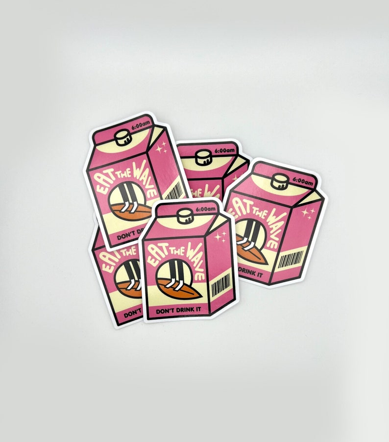 May include: Multiple stickers depicting a pink milk carton with the text 'Eat the Wave' and 'Don't Drink It'. The carton features a cartoon illustration of legs on a surfboard. Each sticker shows a 6:00am time stamp.  These stickers are ideal for surfers, beach lovers, or anyone who appreciates quirky designs.